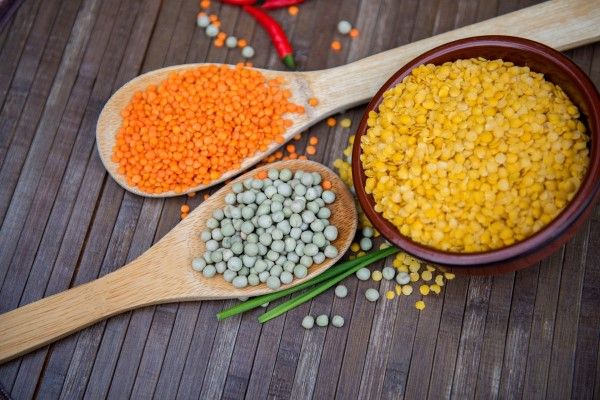 flat-lay-top-view-assorted-beans-including-Dried-Green-Pea-Split-Red-Lentil-Red-Gram-brown-beige-wooden-background