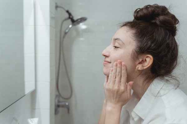 a-young-woman-washing-her-face-with-face-wash