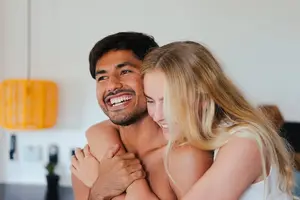 Woman Smiling while Hugging a Man