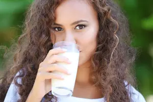 curly hair woman drinking milk