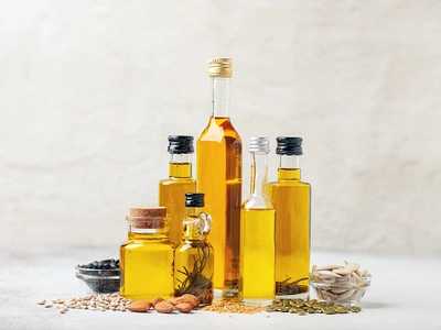 various vegetable and nuts oil in bottles on a bright background