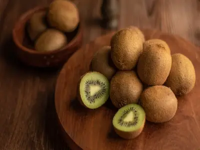 winter fruit Kiwi kept on brown table