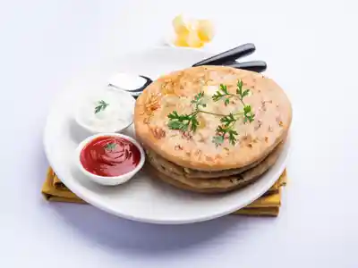 Serve aloo gobhi paratha with tomato souse and curd