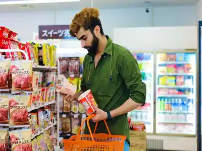 A young man sees price label of packaged food