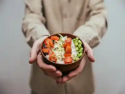 A man showing food in small bowls to cut calories
