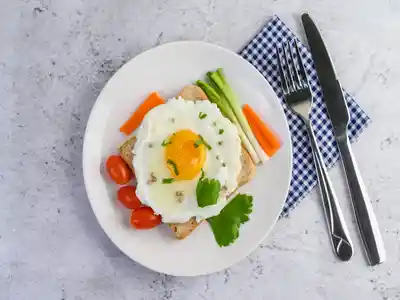 Egg omelet topped on toast with carrots spring onions