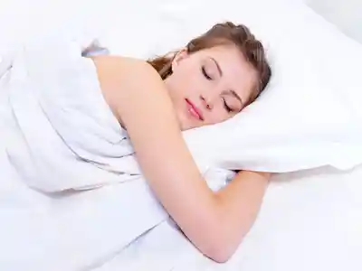 Beautiful young woman sleeping on the bed