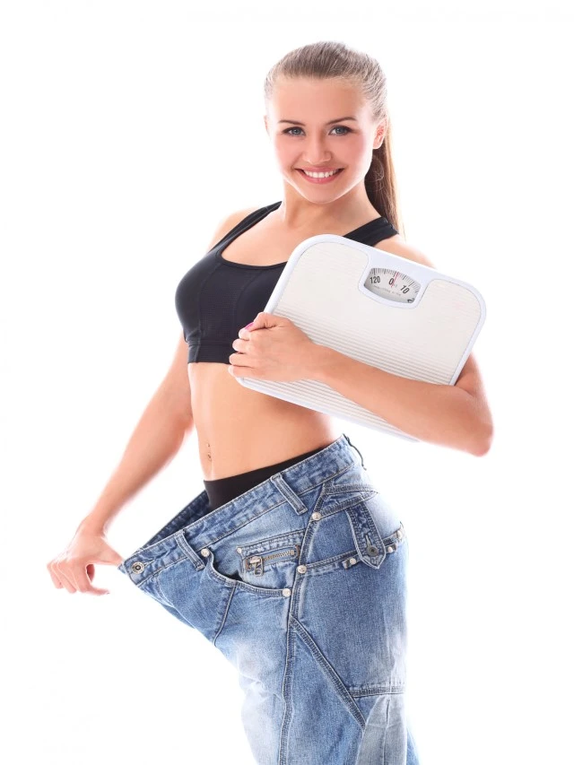 Woman wearing old jeans after weight loss