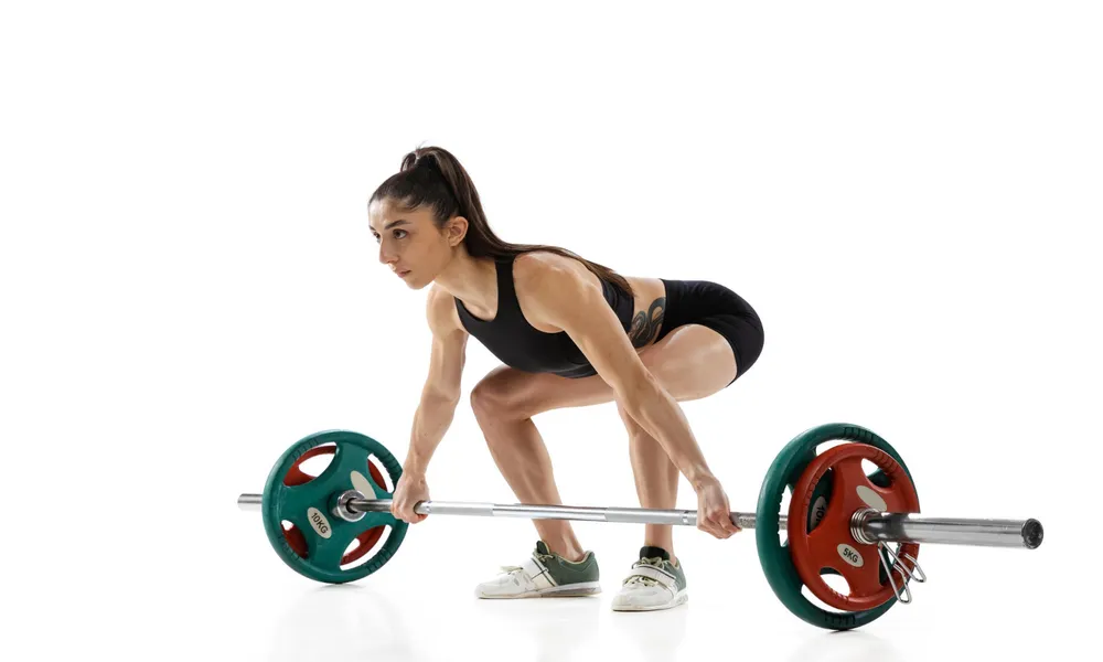 Young female weightlifter workout with weight barbell