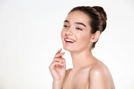 Beauty portrait of smiling young woman with healthy skin nourished with face packs