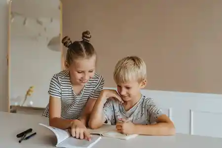 Sister Helping her Brother with Homework