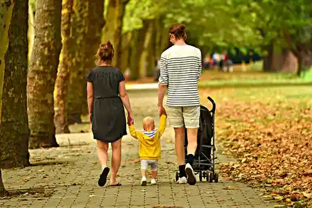 Parents walking in park with his child
