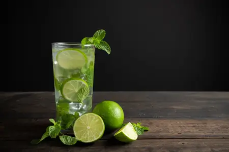 lemon mint drink with lime kept on wood table