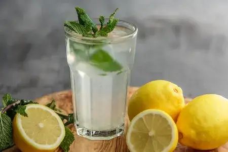 Nimbu sharbat glass with lemon on table