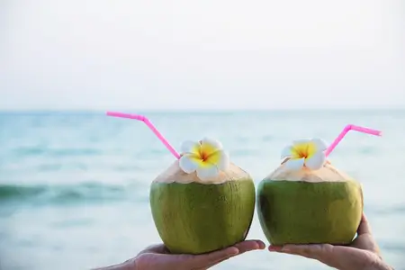 fresh coconut water on couple hands