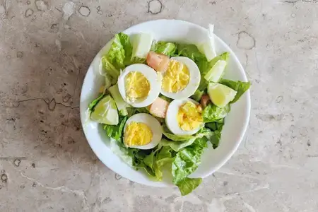 catted boiled egg pieces served on a white plate