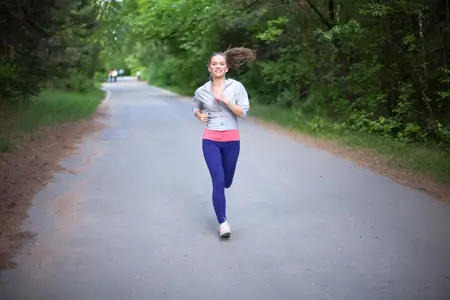 happy-young-woman-jogging-in-park