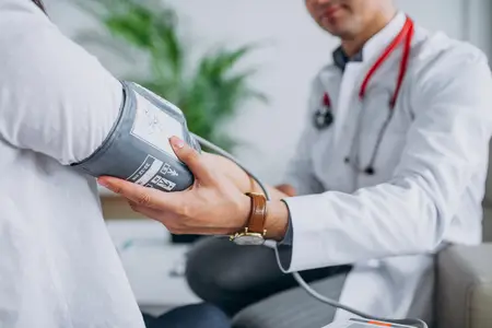 a-doctor-measuring-the-blood-pressure-of-a-young-male-patient