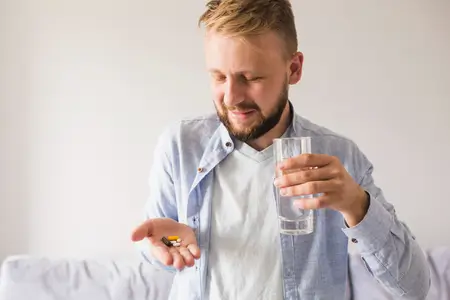 man-taking-vitamins-supplementary-pills