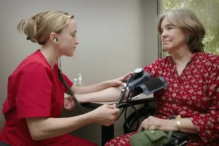 female-doctor-checking-elder-patient- blood-pressure