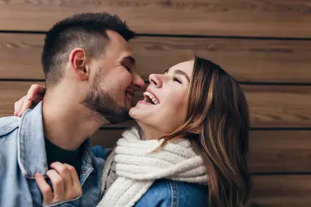 laughing-wife-husband-expressing-his-love-by-kissing