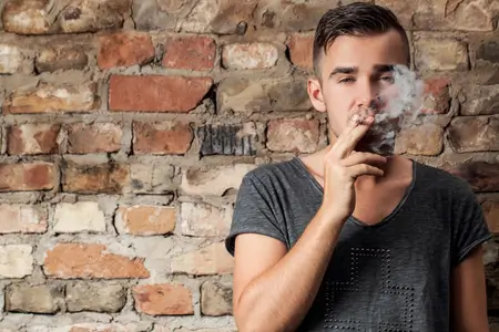 handsome-guy-smoking-near-the-wall