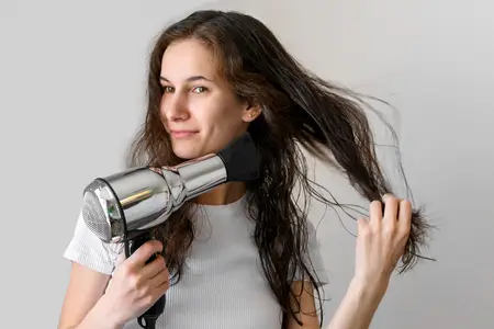 woman-drying-hair-with-hair-dryer
