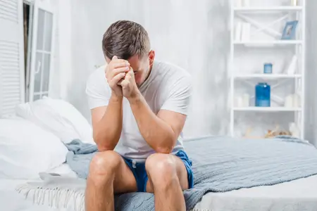 man-suffering-from-infertility-sitting-on-bed