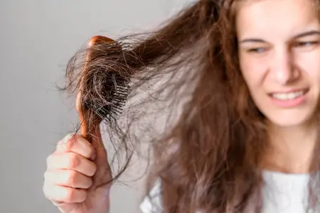 woman-struggling-to-brush-hair